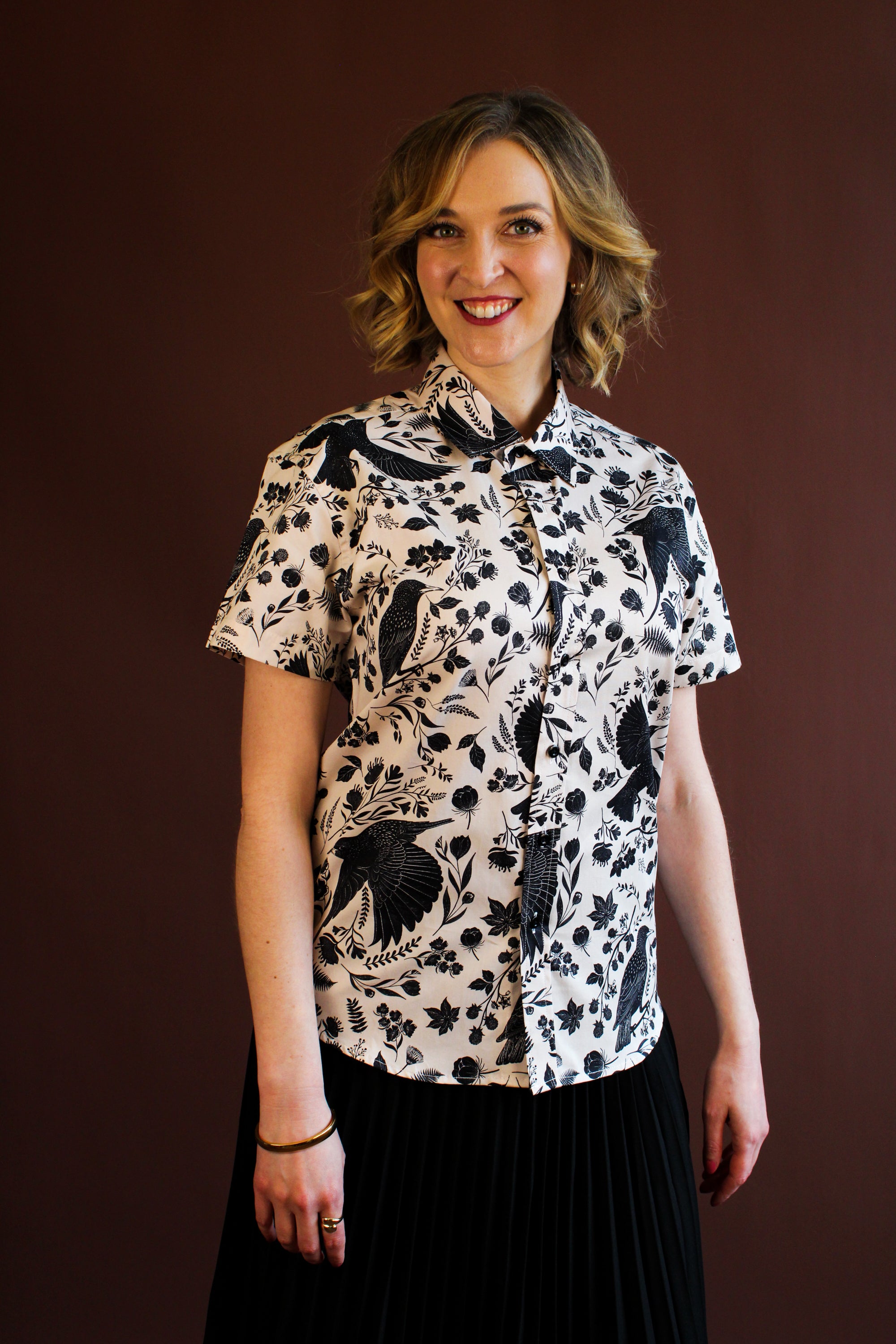 Simone Top in the hand-painted Starling Bird print — organic-cotton top with black starlings and foliage, by Hemloya.