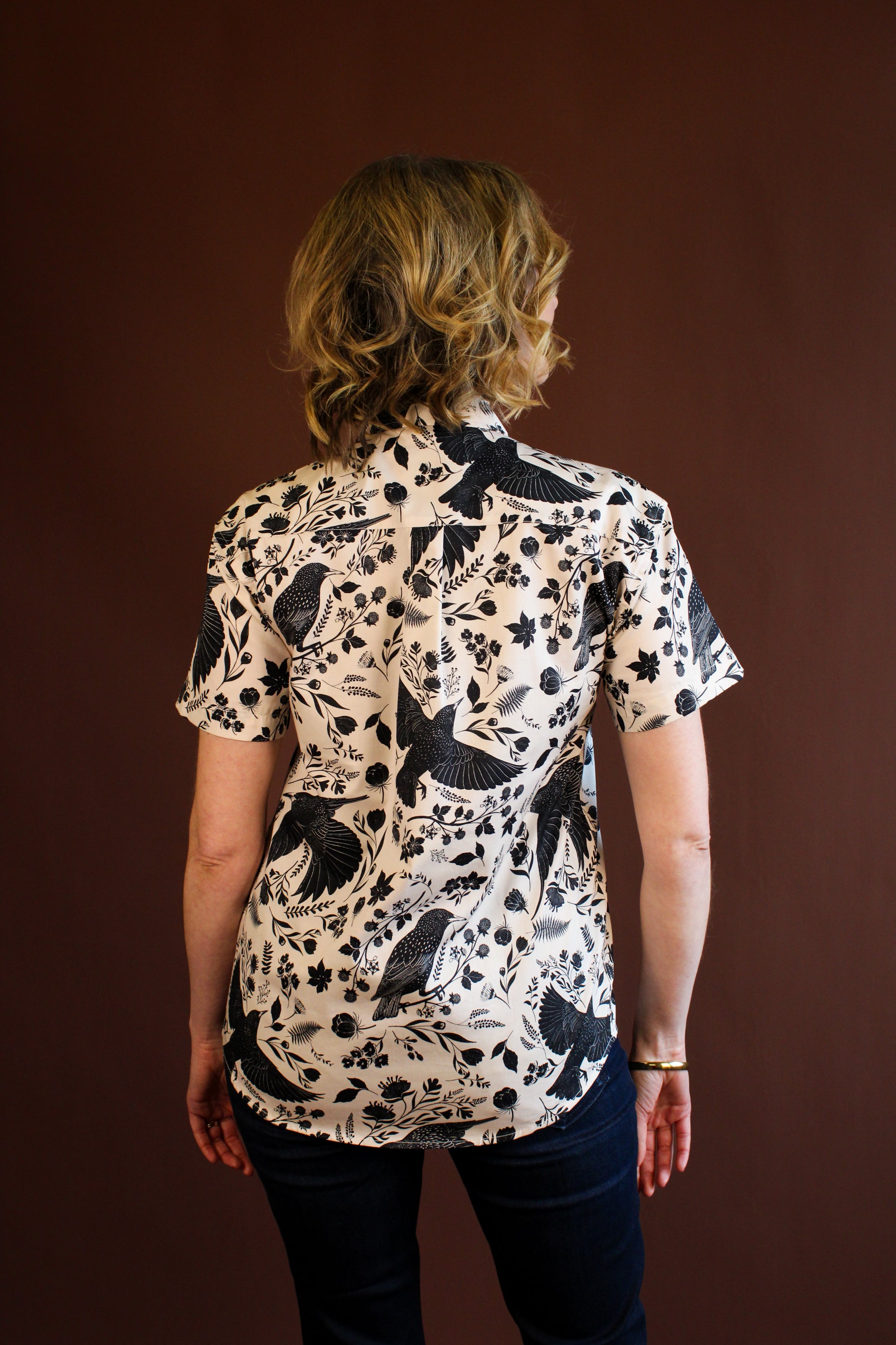 Simone Top in the hand-painted Starling Bird print — organic-cotton top with black starlings and foliage, by Hemloya.